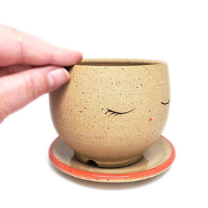 Planter - Peaceful Face (Red Saucer) by Jennifer Fujimoto