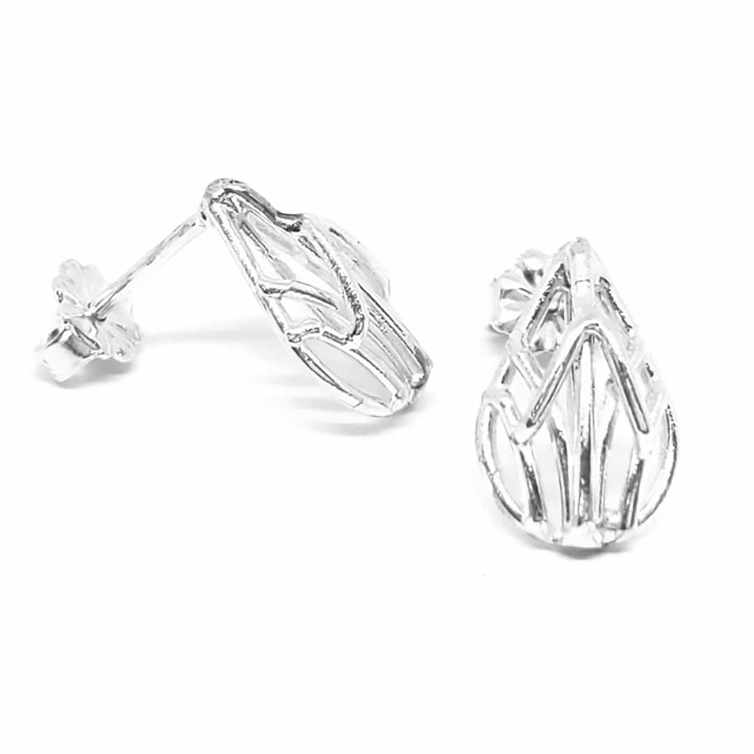 Bright silver-colored sculptural stud earrings with openwork style in teardrop shape