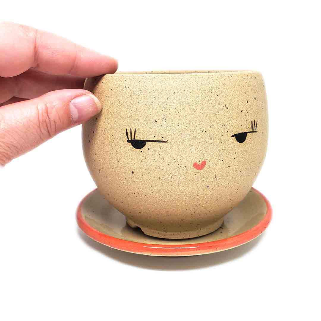 Planter - Side Eye Face (Red Saucer) by Jennifer Fujimoto